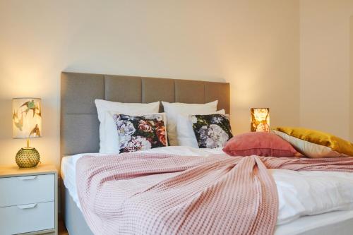 a bedroom with a large bed with pillows at Residence Rybna 9- Old Town in Prague