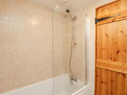 a bathroom with a shower with a bath tub at Barnaby Cottage in Yarm