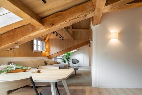 a living room with wooden ceilings and a table at NORO Plaza in A Coruña