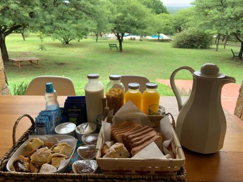 a basket of bread and other food on a table at Casas de Campo Henin in Villa General Belgrano