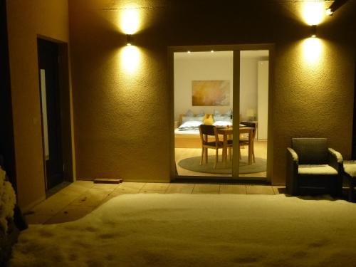 a room with a table and a bedroom with a bed at Cozy mountain view apartment with terrace and garden in Innsbruck
