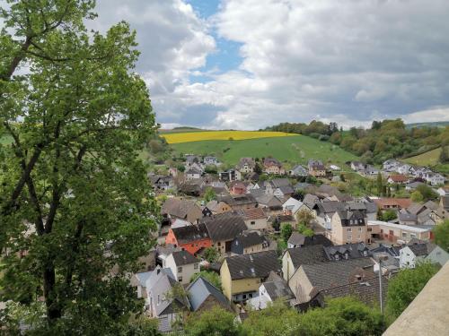 a small town with houses and a green field at Gästehaus "Auszeit" in Burgschwalbach