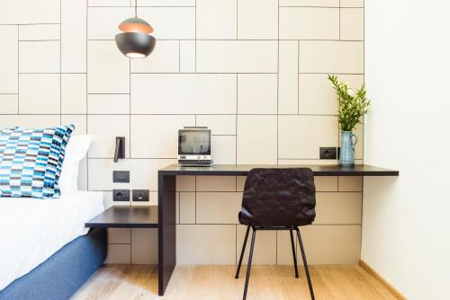 a bedroom with a desk with a computer on it at Hotel Milu Florence in Florence