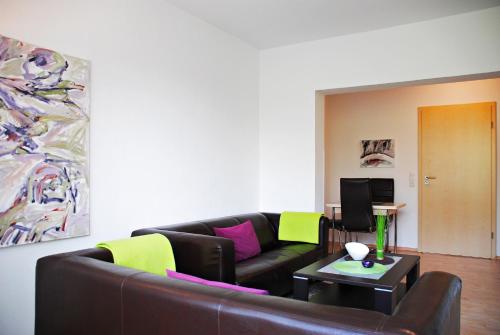 a living room with a couch and a table at Appartementanlage-Ferienwohnungen Weiße Möwe in Sassnitz