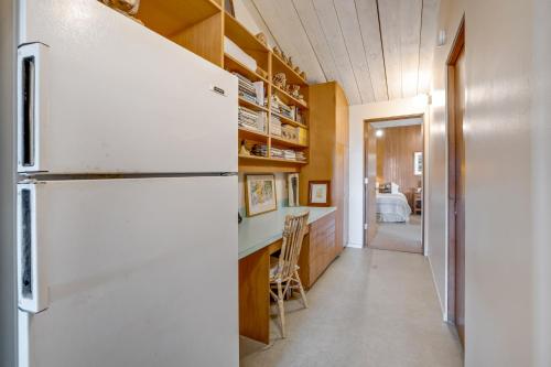 a kitchen with a white refrigerator and a hallway at Eurella in Annapolis