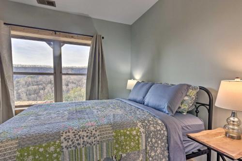 a bedroom with a bed and a window at Hilltop Cabin on 5 Acres with Hot Tub and Waterfall! in Bryson City