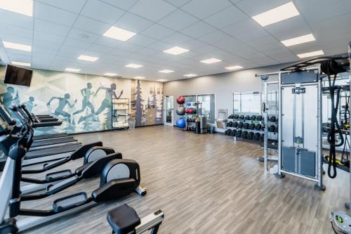 a gym with treadmills and machines in a room at Hyatt House Winnipeg South Outlet Collection in Winnipeg