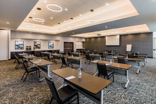 a classroom with tables and chairs and a chalkboard at Hyatt House Winnipeg South Outlet Collection in Winnipeg