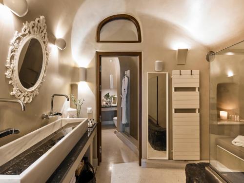 a bathroom with a sink and a mirror at Luxury Villa Blue Dome Santorini in Imerovigli