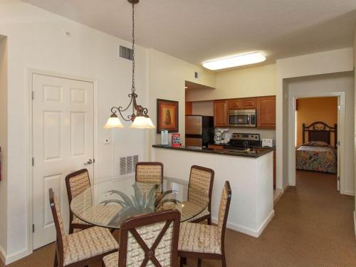 a kitchen and dining room with a table and chairs at Luxury Resort Condo, 2 or 3 BR, Premium suites in Orlando