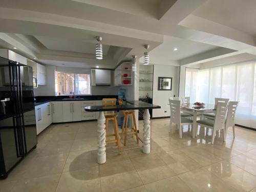 a kitchen with a table and chairs in a kitchen at Apartamentos Martinez in San Andrés