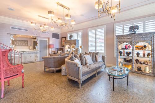 a living room with a couch and chairs and a table at Henrosa Hotel in Miami Beach