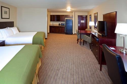 a hotel room with two beds and a desk at Holiday Inn Express Hotel & Suites Syracuse North Airport Area by IHG in Cicero