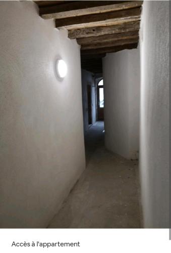 an empty hallway in a building with a light at Nuit Romantique, Spa, Champagne, Cinéma, Flipper - Escapade Veyloise in Pont-de-Veyle