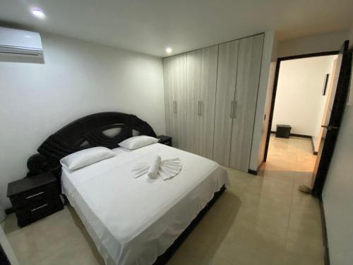a bedroom with a large white bed with white pillows at Apartamentos Martinez in San Andrés