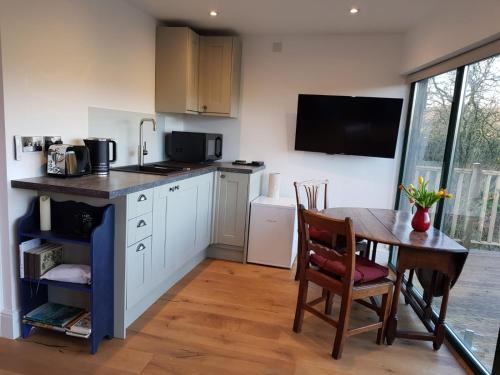 a kitchen with a table and a dining room at The Sett on The Wharfe in Threshfield