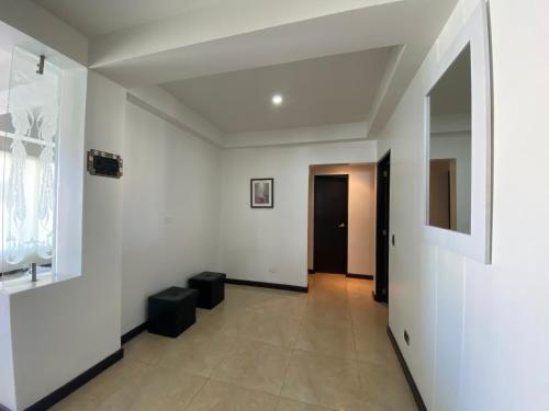 an empty room with white walls and a hallway at Apartamentos Martinez in San Andrés