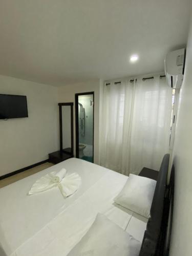a white bed with a white bow on top of it at Apartamentos Martinez in San Andrés