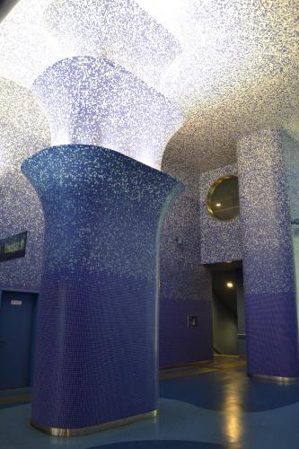 a room with a blue wall with a shiny ceiling at Monaciello in Naples