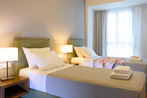 Ένα ή περισσότερα κρεβάτια σε δωμάτιο στο Elounda Colour Apartments