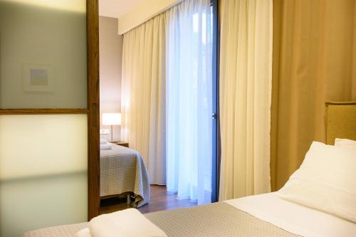 Ένα ή περισσότερα κρεβάτια σε δωμάτιο στο Elounda Colour Apartments
