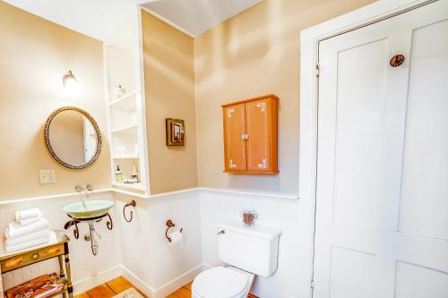 a bathroom with a toilet and a sink and a mirror at Lincoln Escape in Lincoln