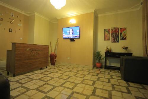 a living room with a flat screen tv on the wall at Precious Villas Lubowa in Kampala