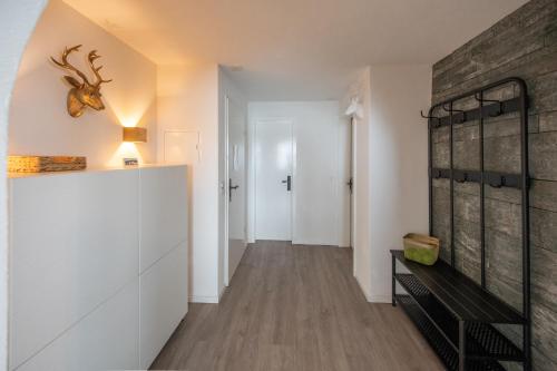a hallway with white cabinets and a brick wall at Agrimonia - möbilierte Ferienwohnung mit Balkon in Davos