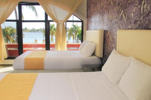 Postel nebo postele na pokoji v ubytování Hotel Gran Palmeiras