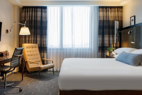 a bedroom with a bed and a desk and a chair at Kimpton Overland Hotel - Atlanta Airport, an IHG Hotel in Atlanta