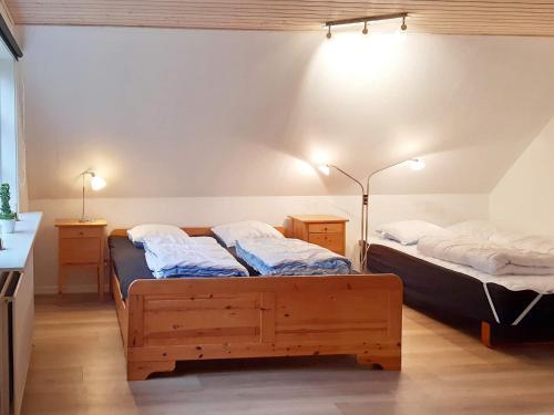 two twin beds in a room with two lamps at 20 person holiday home in Silkeborg in Silkeborg