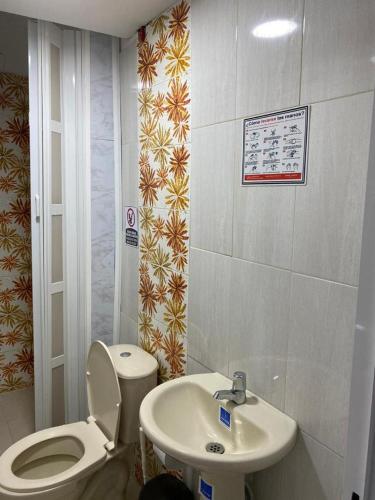 a bathroom with a toilet and a sink at Fuentes House in San Andrés