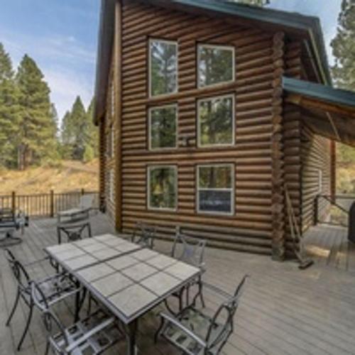 a patio with a table and chairs on a cabin at Cascade Log Cabin by Casago McCall - Donerightmanagement in Cascade