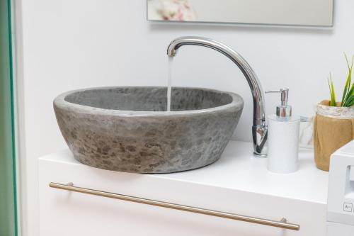 a stone sink on a counter with a faucet at Georgioupoli Studios in Georgioupolis