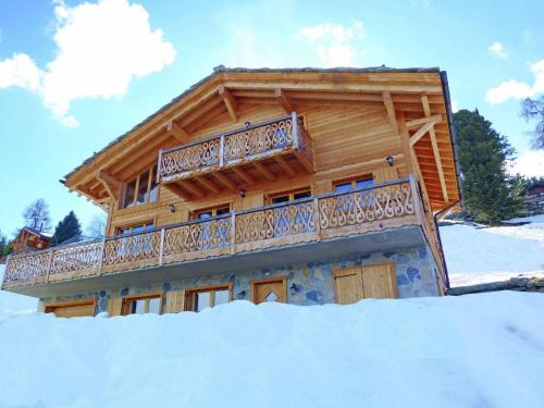 a log cabin with a balcony in the snow at Modern Chalet with bubble bath in Les Collons in Les Collons