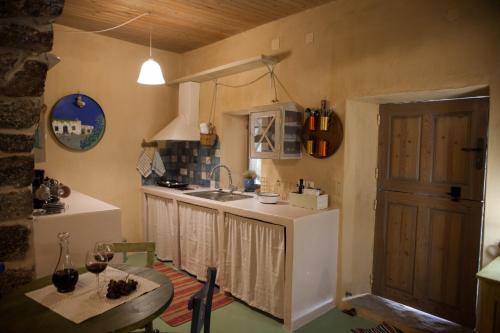a kitchen with a sink and a table in a room at Sitanos Anna House in Sítanos