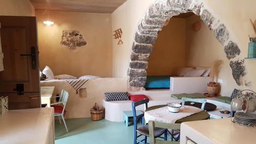 a room with a kitchen and a room with a table and chairs at Sitanos Anna House in Sítanos