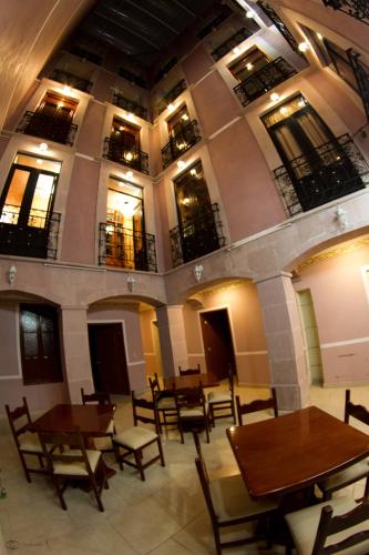 a room with tables and chairs in a building at Cuartel 1914 - Hotel Boutique in Zacatecas