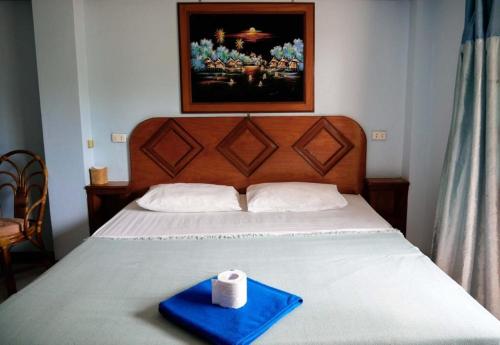 a blue tray with a roll of toilet paper on a bed at Lam Sai village hotel Koh Yao Noi in Ko Yao Noi