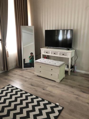 a person taking a picture of a television in a living room at Super Wonderful 5 bedrooms with Bathroom Villa Marion Tomohon in Tomohon