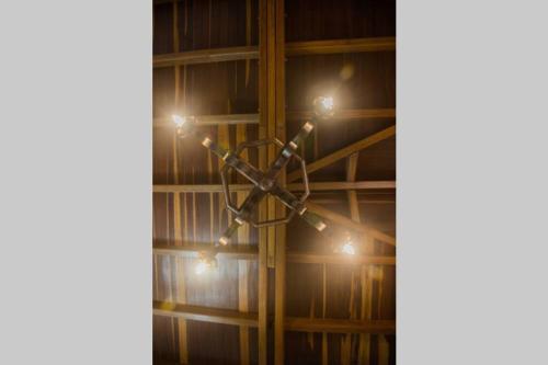 a cross hanging from a ceiling with lights on it at Los Tulios Alojamiento in Circasia