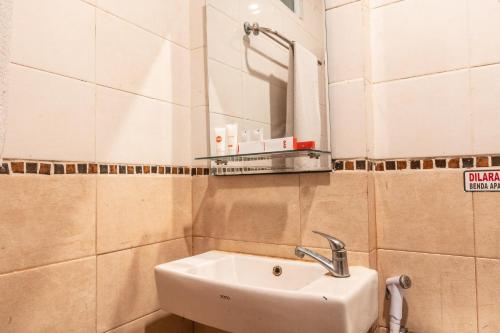 a bathroom with a sink and a mirror at The Kartini 8 Residence - Mangga Besar in Jakarta