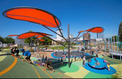 a group of people at a playground with people playing at Perfect modern Townhouse CBD Christchurch in Christchurch