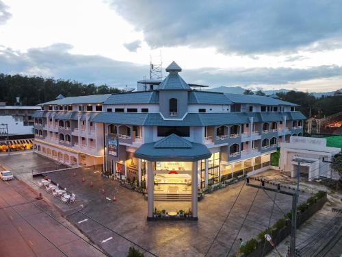 a large building with a gazebo in front of it at Grandview Landmark Betong Hotel in Betong