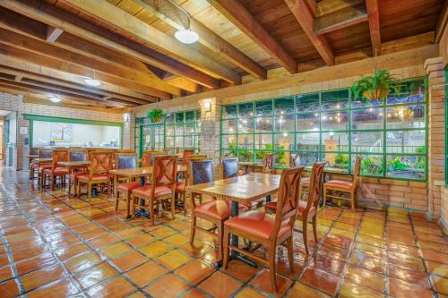 a restaurant with tables and chairs in a room at Clarion Inn in Sierra Vista