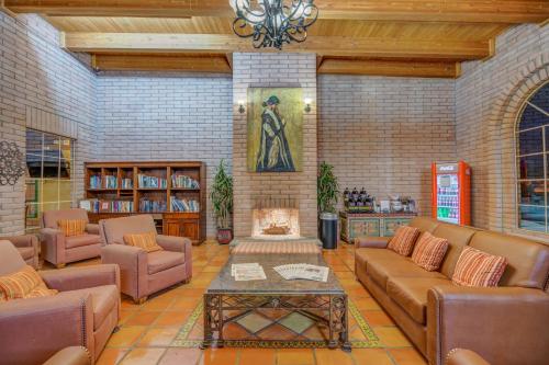 a large living room with couches and a fireplace at Clarion Inn in Sierra Vista