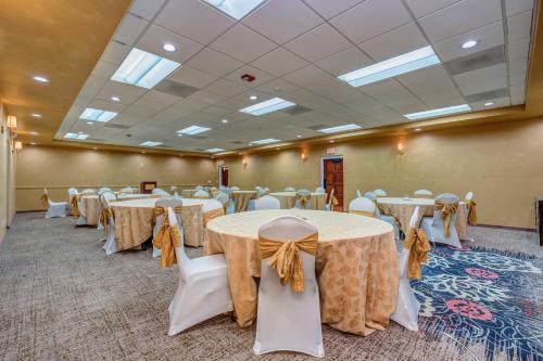 a banquet hall with tables and chairs with bows at Clarion Inn in Sierra Vista