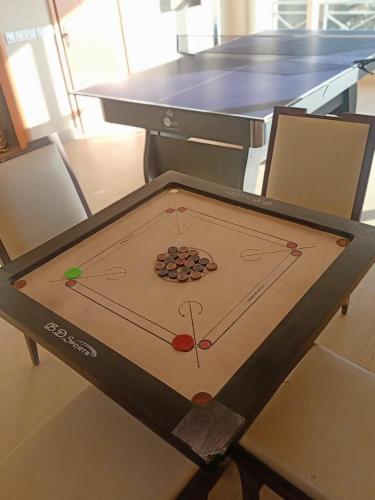 a ping pong table with balls on top of it at Yog Wellness Resort & Spa By Amritara in Mussoorie