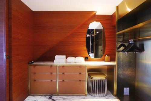 a bathroom with a sink and a staircase with towels at The Macau Roosevelt Hotel in Macau