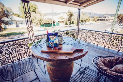 a table on a balcony with a view of a street at 70 On Mortimer in Mudgee